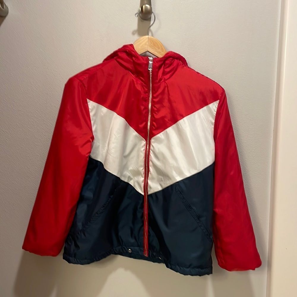 H and M Divided woman’s blue, white and red puffer jacket.